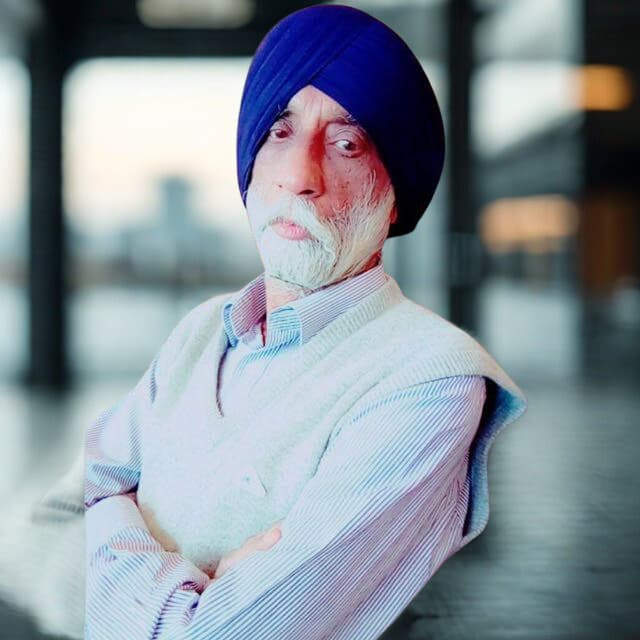 Portrait of an esteemed elderly Indian gentleman, looking wise and kind.